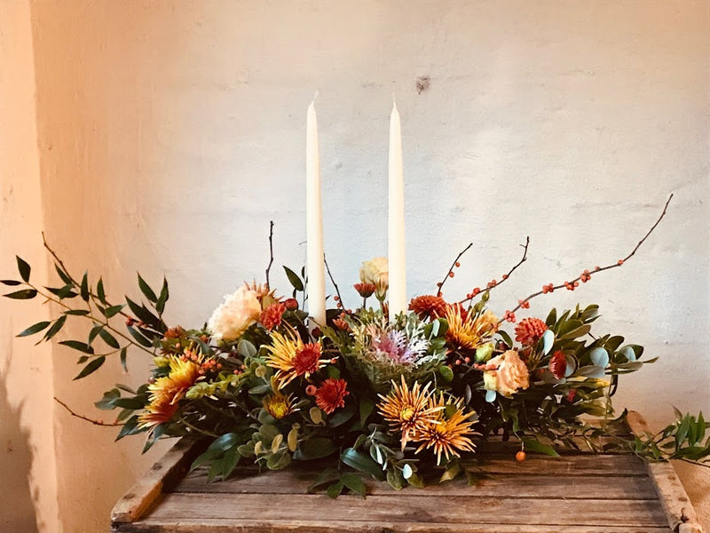 Gorgeous thanksgiving centerpiece made of local flowers from Rhode Island in a low and lush style with candles