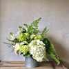 Clean modern arrangment of white and green flowers and foliages